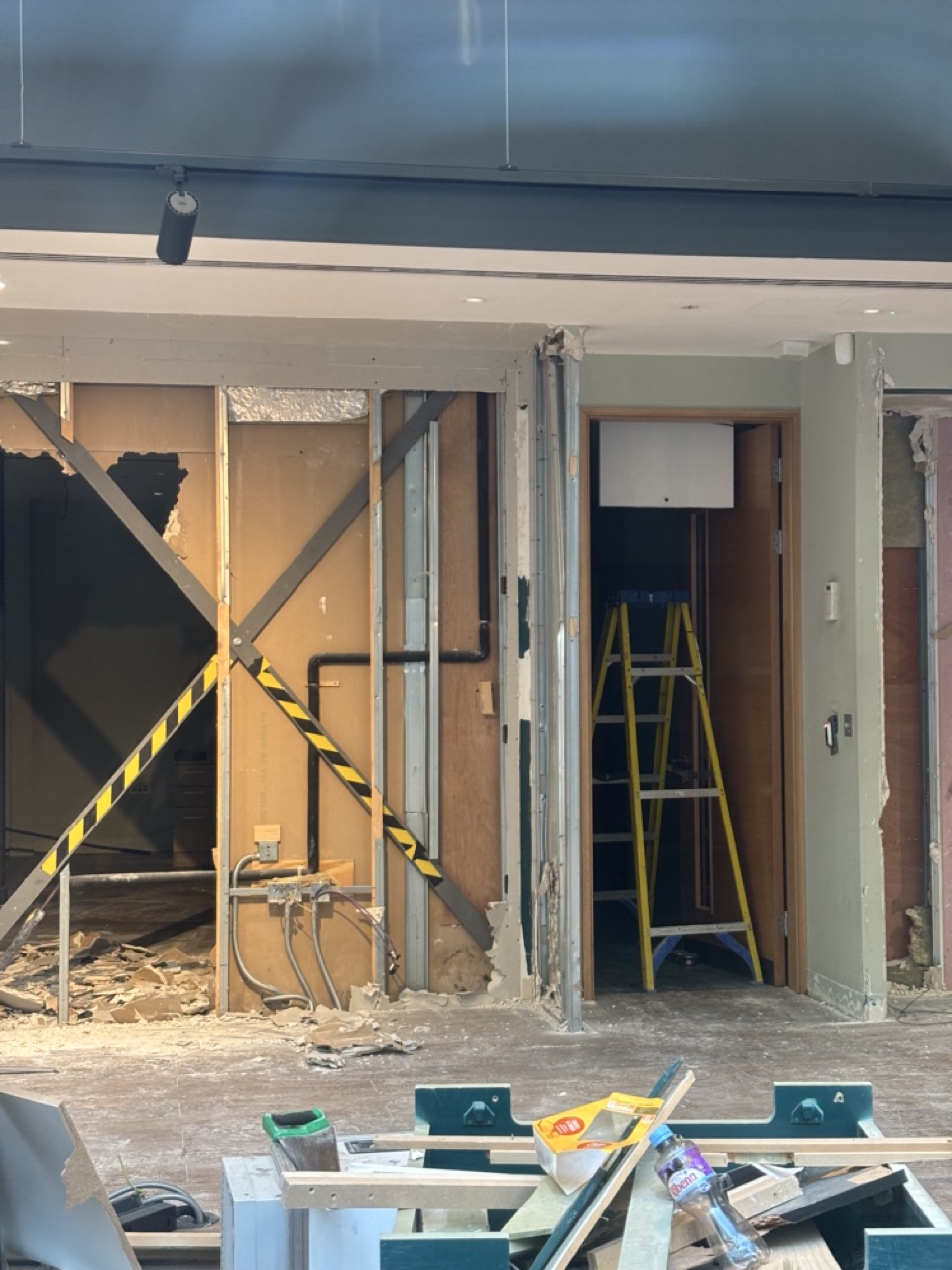 Photograph of interior building renovation, broken walls